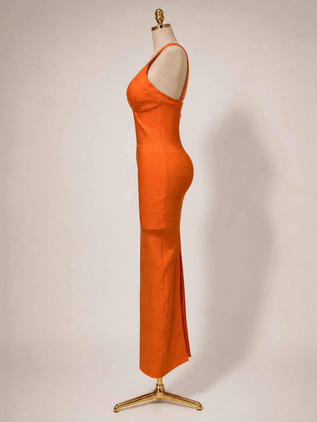 from allureOrange evening gown on a mannequin against a plain background