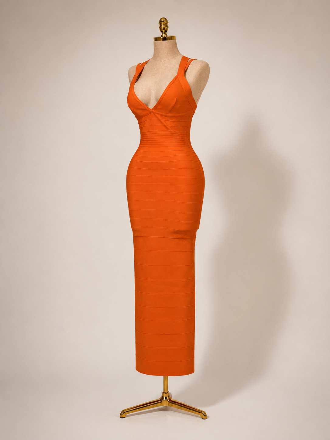 Orange from allure  dress on a mannequin against a plain background