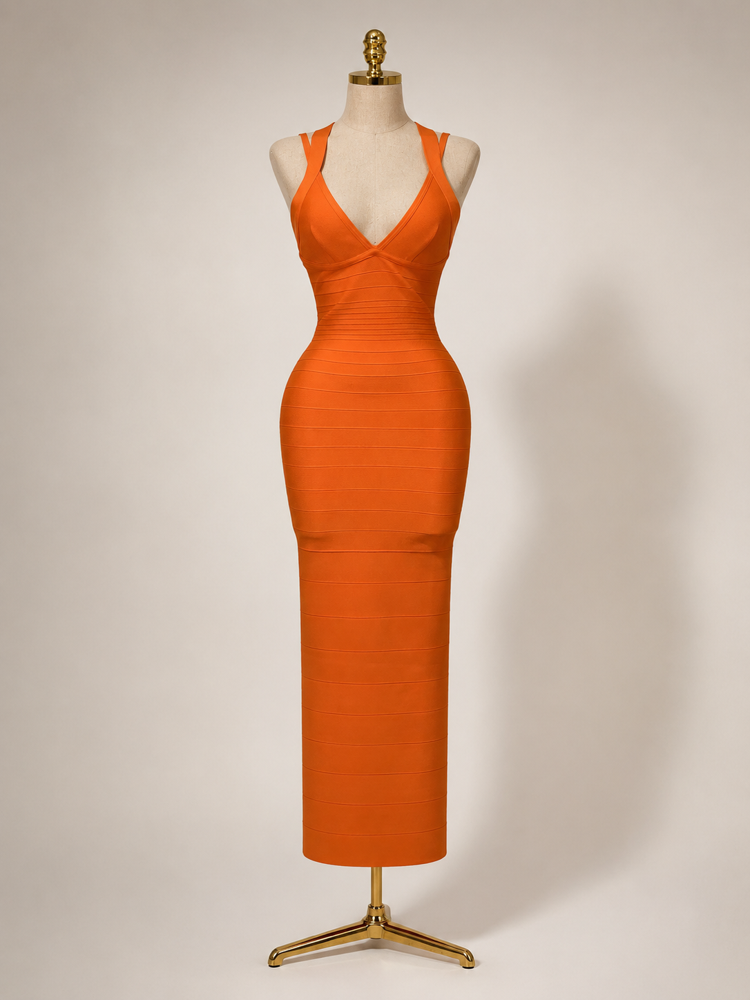 Orange bandage dress from allure on a mannequin against a plain background